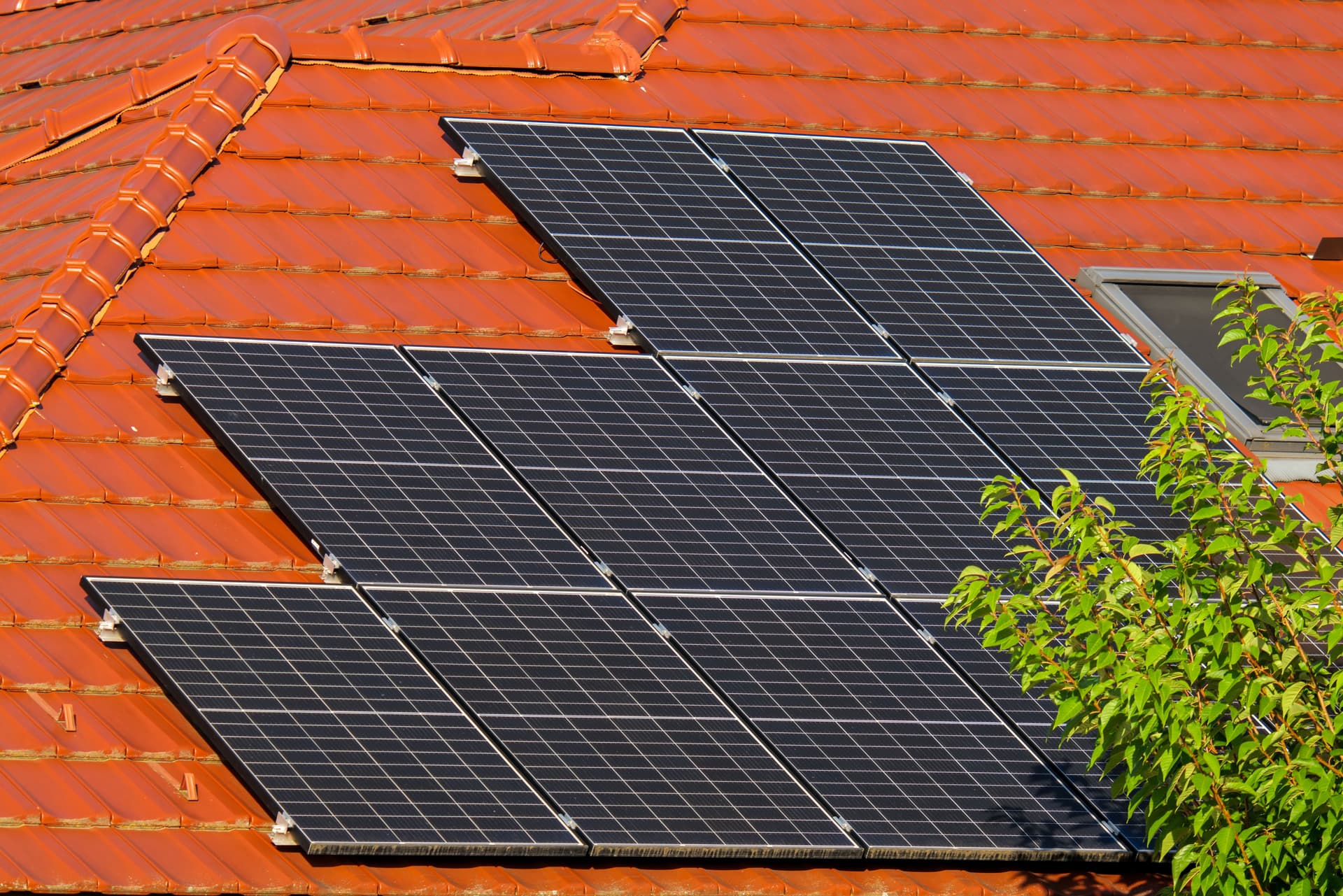 Rooftop solar panels on a tiled roof, kept clear for full sun exposure.